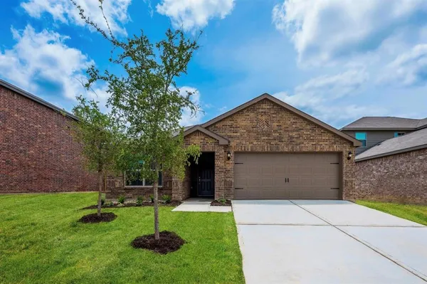 a view of a house with a backyard and a tree
