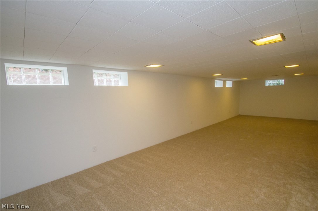 10571 Snow Road Parma Heights, OH 44130 - Photo 18 of 25 Lower level Rec room with newer carpet and glass block windows