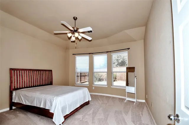 a bedroom with a large bed and a tv