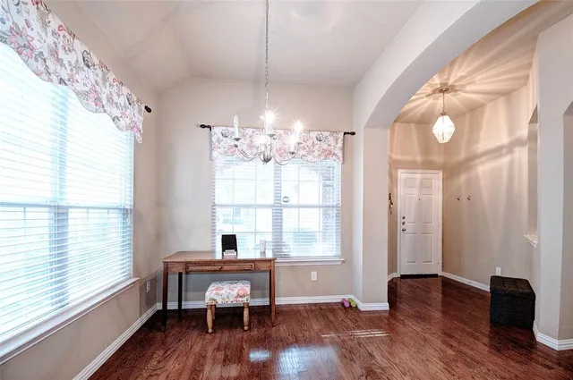 a view of a room with wooden floor and windows
