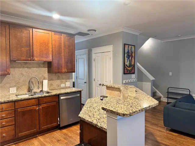 a view of a kitchen with wooden floor and a window