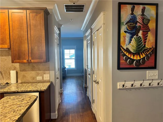 a view of entryway and hall with wooden floor