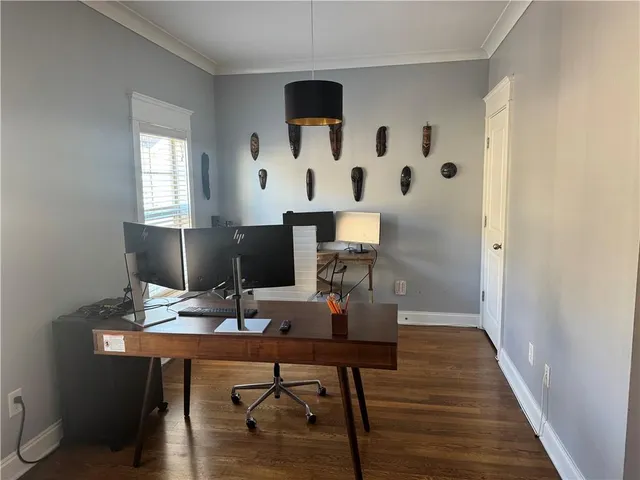 a view of a workspace with furniture and wooden floor