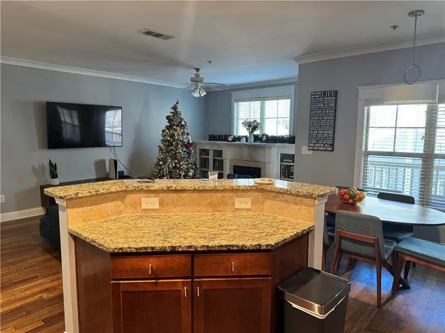 a dining room with furniture a chandelier and wooden floor