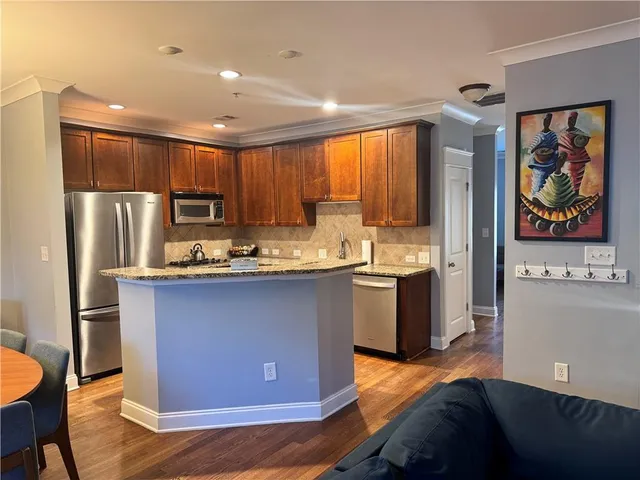 a dining room with a wooden table and chairs