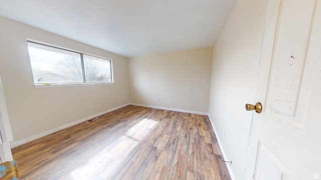 1348 Sagewood Road Price, UT 84501 - Photo 14 of 34 Empty room featuring wood finished floors and baseboards
