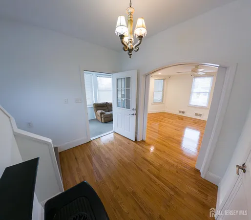 a kitchen with a sink and wooden floor