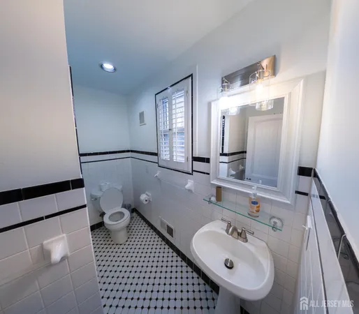 a kitchen with granite countertop white cabinets and wooden floor