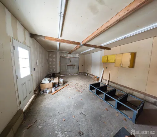 a kitchen with granite countertop a stove top oven a sink dishwasher a dining table and chairs with wooden floor