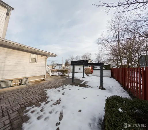 a view of backyard with wooden fence