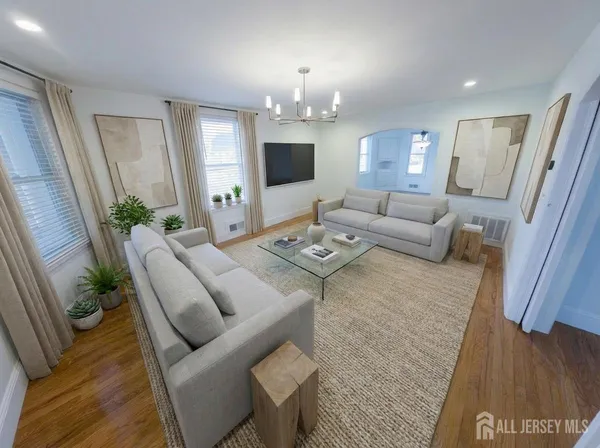 a living room with furniture and a chandelier