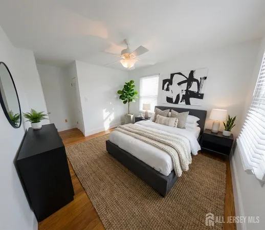 a bedroom with a bed lamp and a potted plant
