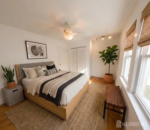 a bedroom with a large bed and a chandelier