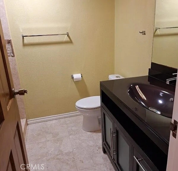 12300 Montecito Road, Unit 42 Seal Beach, CA 90740 - Photo 10 of 22 a bathroom with a granite countertop sink and a toilet