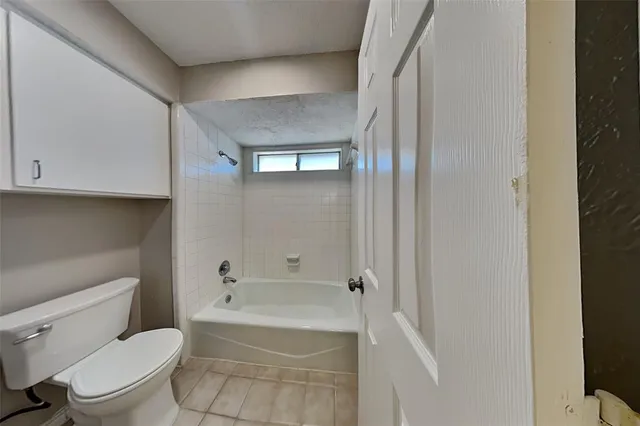 a bathroom with a toilet and a bathtub