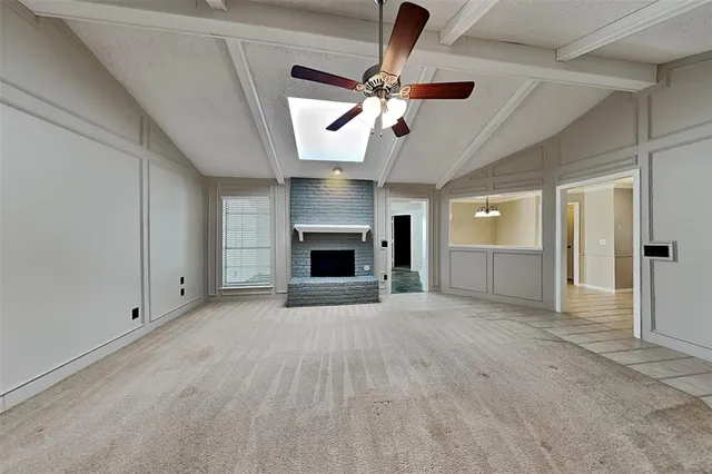 an empty room with ceiling fan and entryway