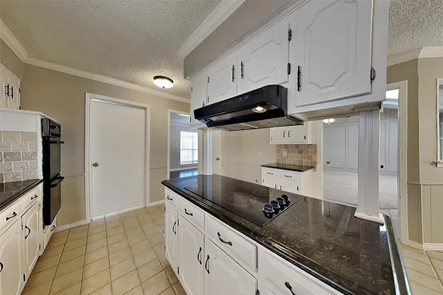 a kitchen with stainless steel appliances granite countertop a sink a stove and a refrigerator