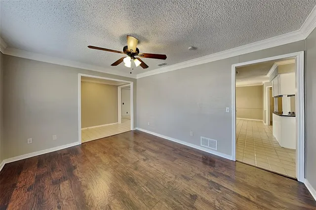 a view of an empty room and wooden floor