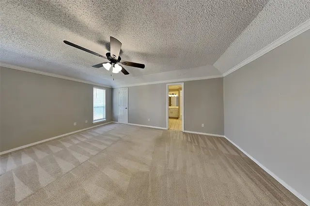 a view of an empty room with a ceiling fan