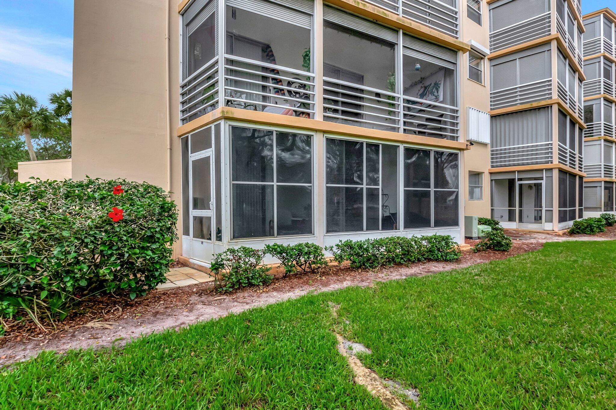 6461 Northwest 2nd Avenue, Unit 1160 Boca Raton, FL 33487 - Photo 25 of 26 a front view of a house with a garden and plants