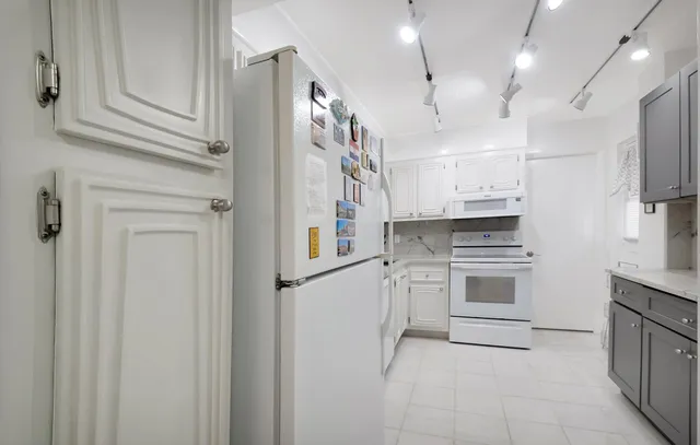 a kitchen with stainless steel appliances a refrigerator sink and cabinets