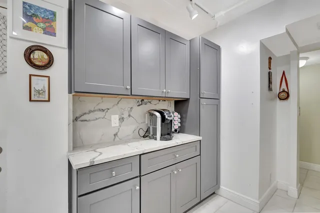 a view of storage and utility area with cabinets