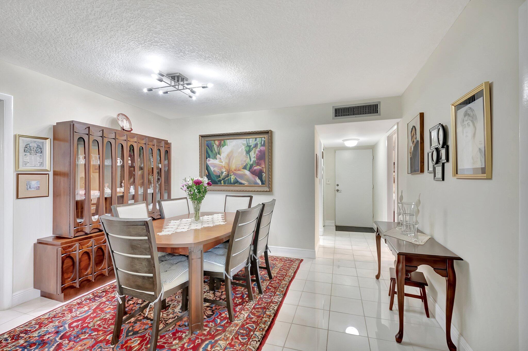 6461 Northwest 2nd Avenue, Unit 1160 Boca Raton, FL 33487 - Photo 5 of 26 a view of a dining room with furniture