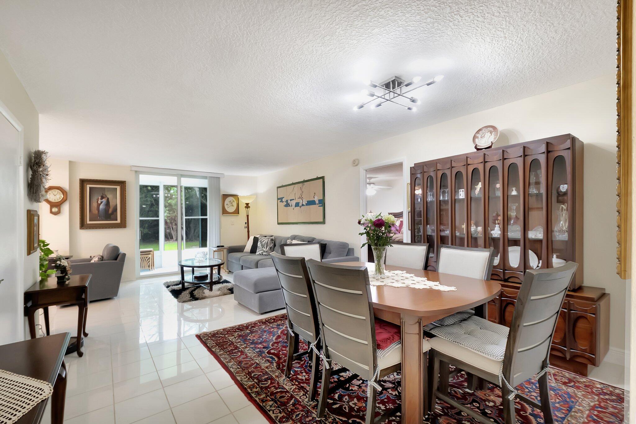 6461 Northwest 2nd Avenue, Unit 1160 Boca Raton, FL 33487 - Photo 8 of 26 a view of a dining room with furniture window and wooden floor