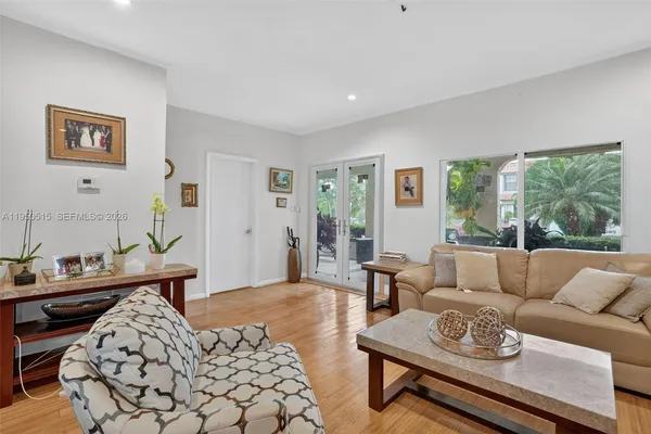 a living room with furniture and wooden floor