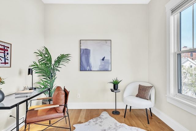 a view of a workspace with furniture and a potted plant