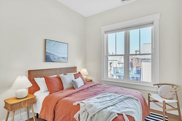 a bed sitting in a bedroom next to a window