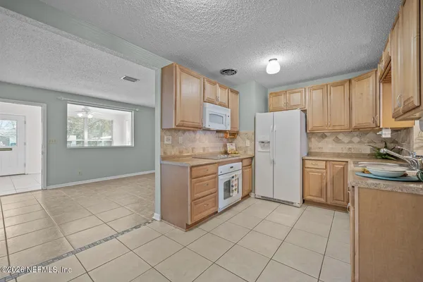 a kitchen with a stove a sink and a refrigerator