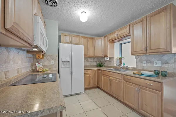 a kitchen with stainless steel appliances granite countertop a refrigerator sink and cabinets