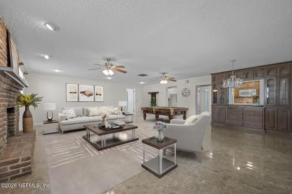 a living room with furniture and a chandelier