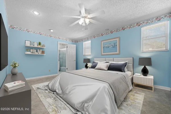 a bedroom with a large bed and a couch