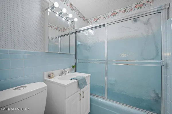 a bathroom with a shower a toilet and sink