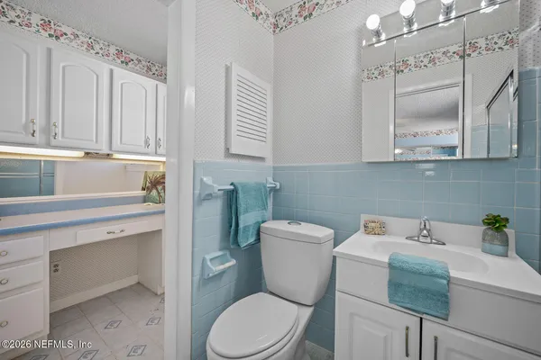 a bathroom with a sink toilet and mirror