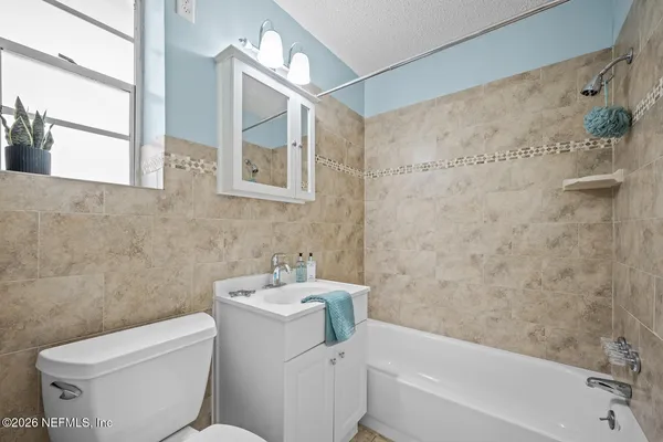 a bathroom with a toilet sink and bathtub