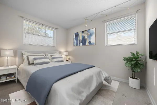 a bedroom with a potted plant and a window