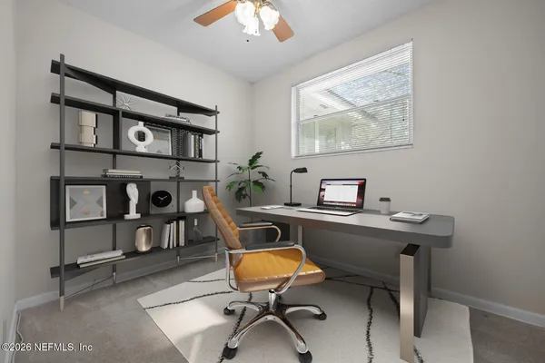 a view of a workspace with furniture
