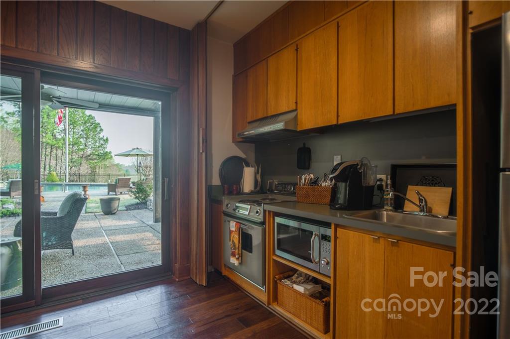 560 Club Road Tryon, NC 28782 - Photo 36 of 48 a kitchen with stainless steel appliances granite countertop a stove a sink and a refrigerator