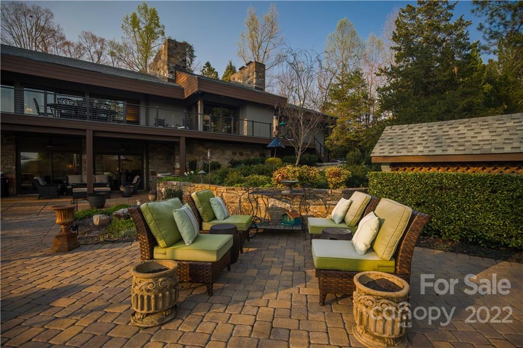560 Club Road Tryon, NC 28782 - Photo 45 of 48 a view of a patio with table and chairs and potted plants