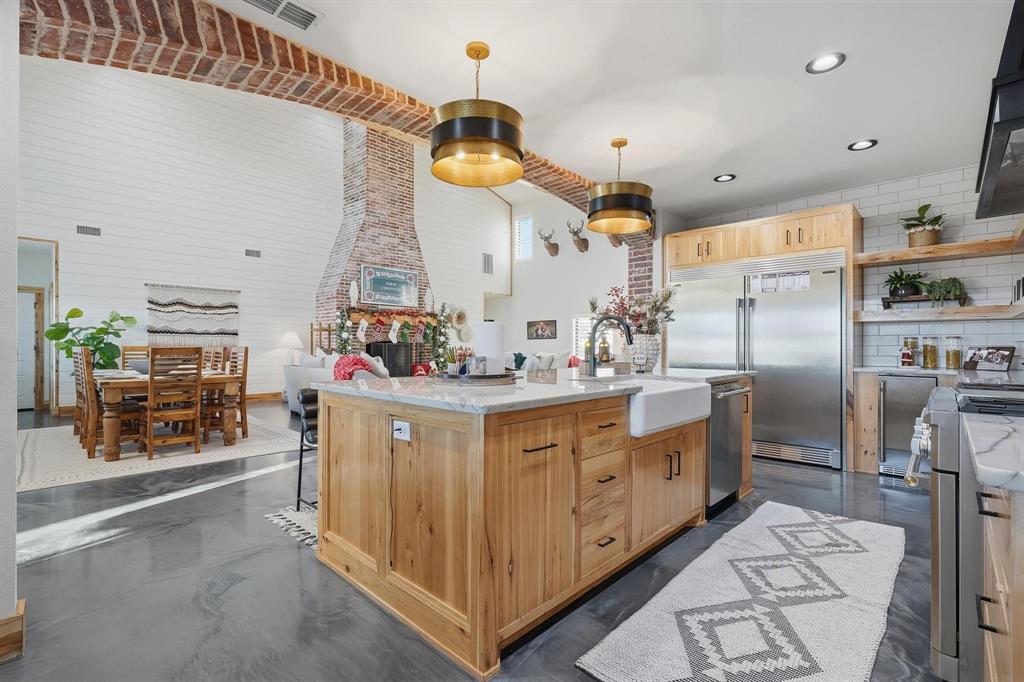 519 Wimberly Road Merkel, TX 79536 - Photo 16 of 40 a kitchen with stainless steel appliances kitchen island granite countertop a stove a sink and a refrigerator