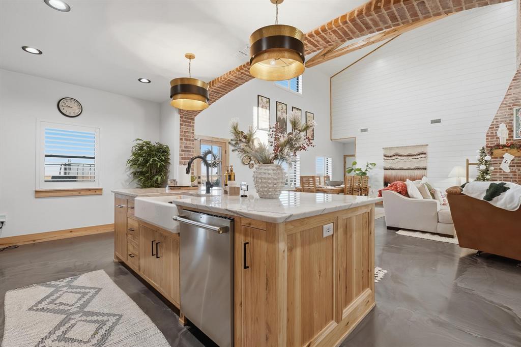 519 Wimberly Road Merkel, TX 79536 - Photo 17 of 40 a kitchen with stainless steel appliances granite countertop a sink a stove and a wooden floors
