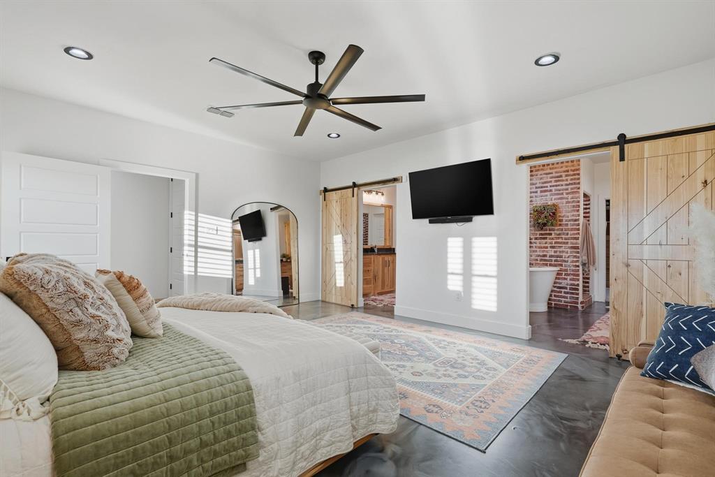 519 Wimberly Road Merkel, TX 79536 - Photo 25 of 40 a bedroom with a bed a flat screen tv and a couch