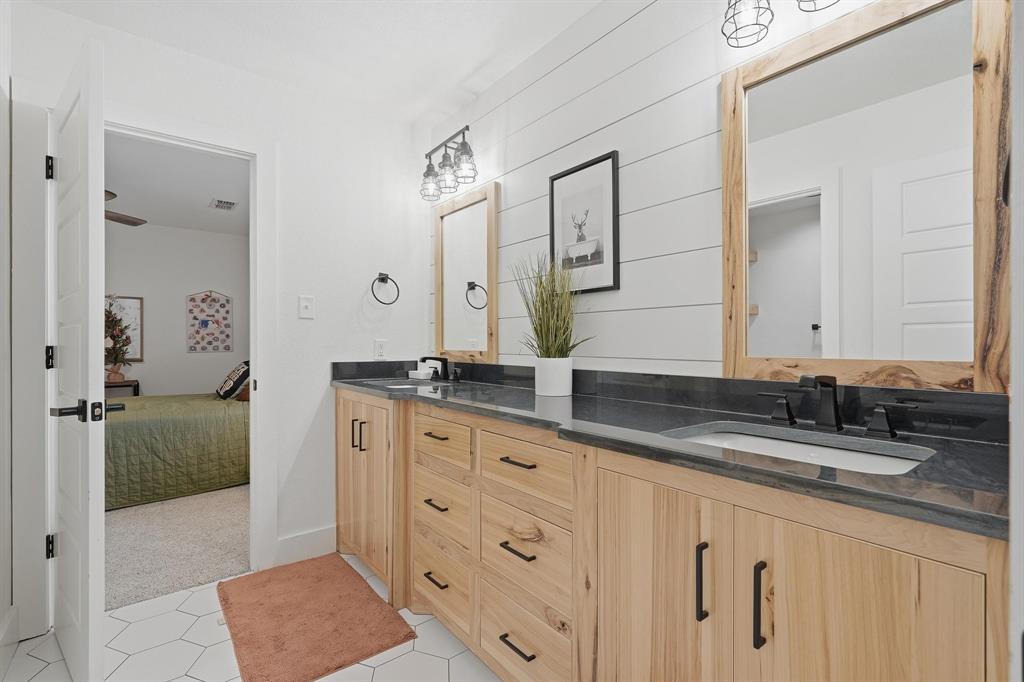 519 Wimberly Road Merkel, TX 79536 - Photo 35 of 40 a bathroom with double sink and a mirror