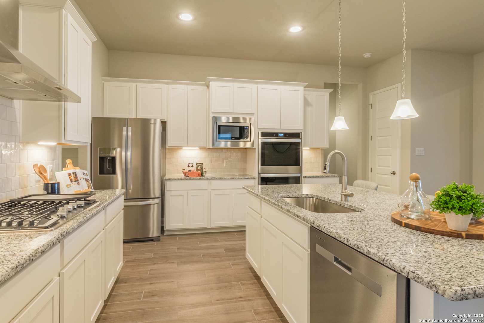 a kitchen with refrigerator a sink and microwave