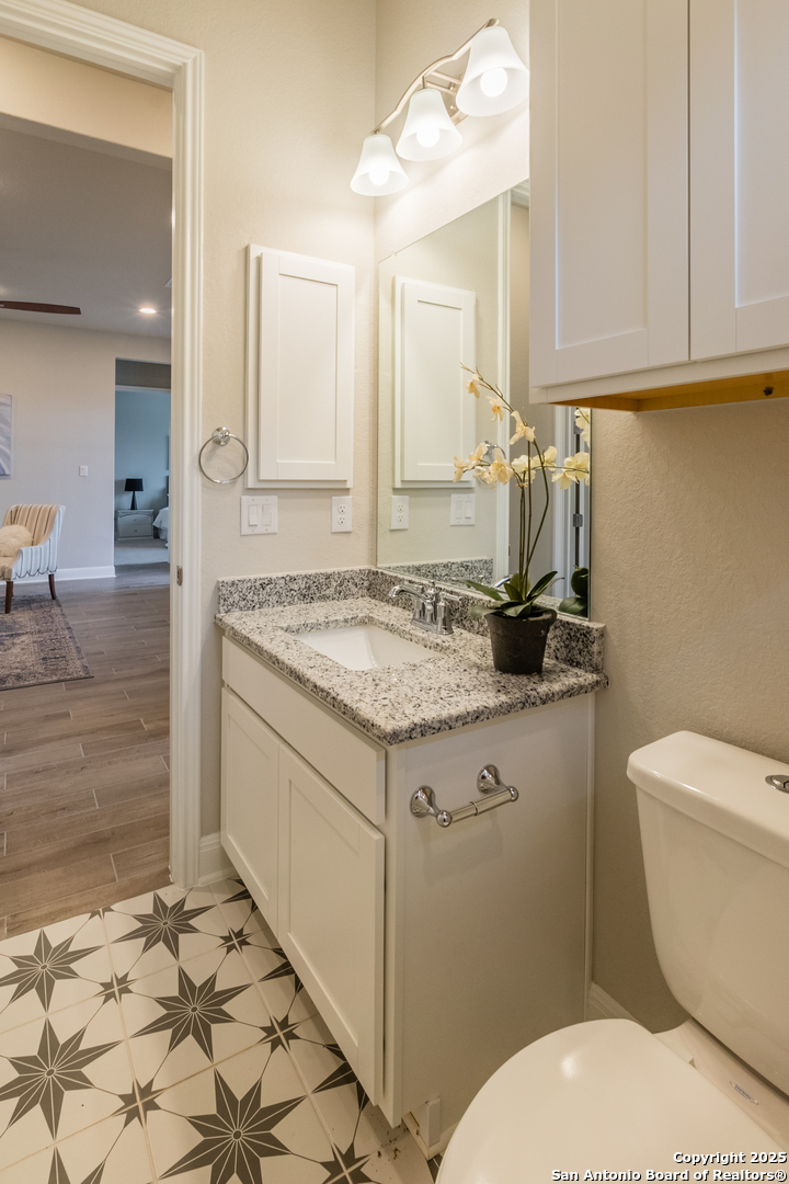 108 Rosanna Ridge Universal City, TX 78148 - Photo 36 of 58 a bathroom with a granite countertop toilet sink and mirror