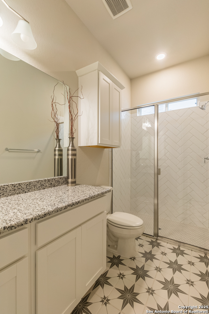 108 Rosanna Ridge Universal City, TX 78148 - Photo 42 of 58 a bathroom with a granite countertop sink toilet and shower