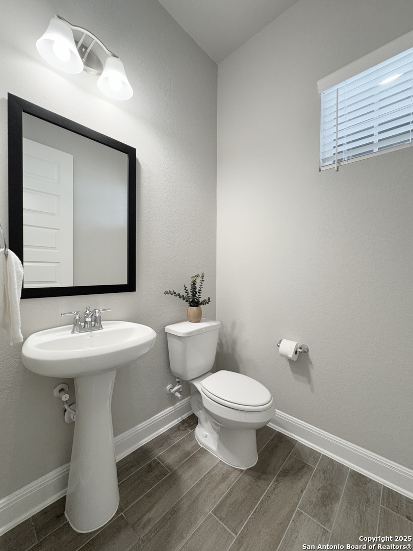 108 Rosanna Ridge Universal City, TX 78148 - Photo 6 of 58 a bathroom with a toilet sink and mirror